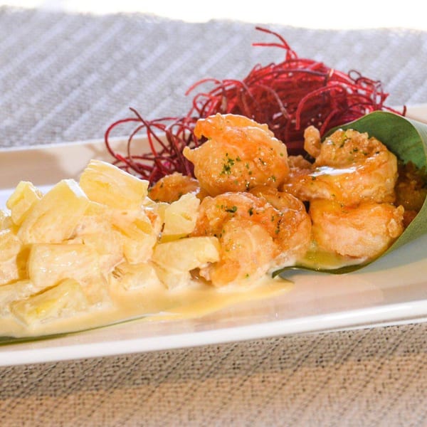 Kirin Asian Cuisine & Sushi's crispy shrimp with creamy sauce, pineapple chunks, and red garnish.